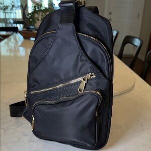 Elegant Black Nylon Crossbody Backpack with Gold Accents